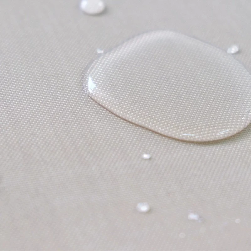 Water drops resting on a coated fiberglass fabric surface