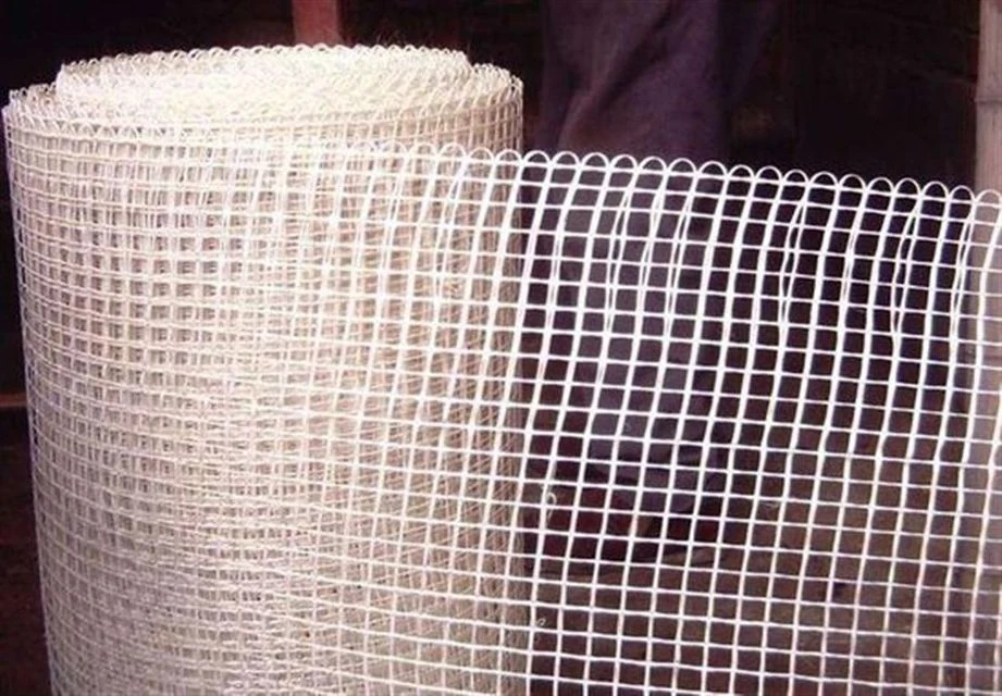 White open mesh fabric unwound from a roll