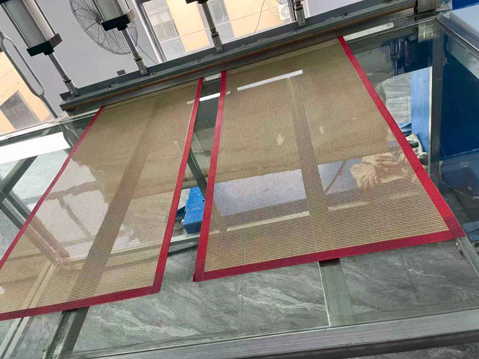 Two reinforced mesh panels resting on an equipment support