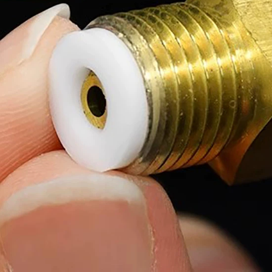A PTFE sealing washer seated against a brass instrument fitting