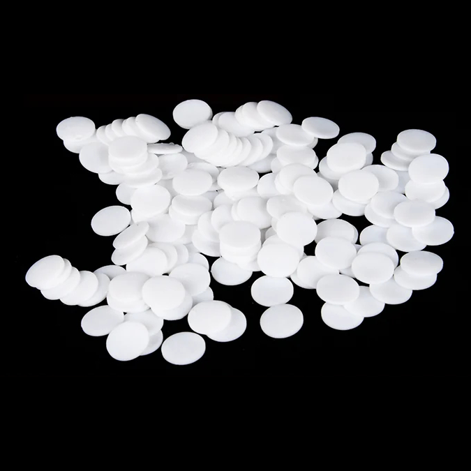 An assortment of white unperforated PTFE round discs