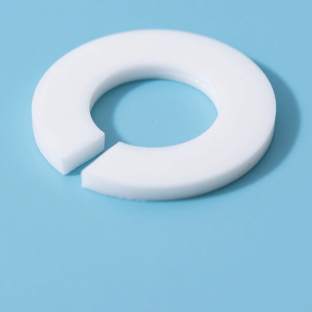 White PTFE split washer viewed at an oblique angle