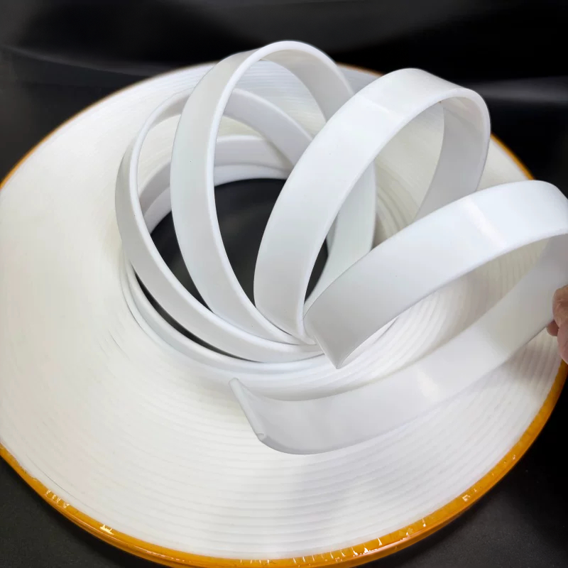 White virgin PTFE guide strips opened into loops above a coil