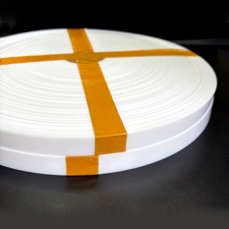 The edge and wound layers of a white virgin PTFE strip coil